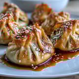 Crispy air fryer chicken dumplings with sesame soy sauce, golden and juicy, served with savory dipping sauce.  