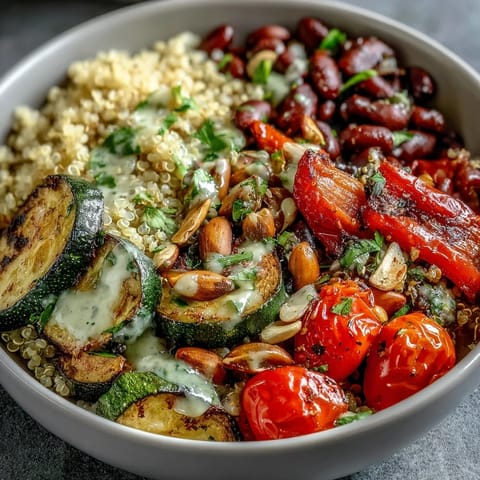A nourishing Veggie and Quinoa Power Bowl with crunchy almonds, creamy beans, and vibrant roasted veggies drizzled with tangy lemon dressing.
