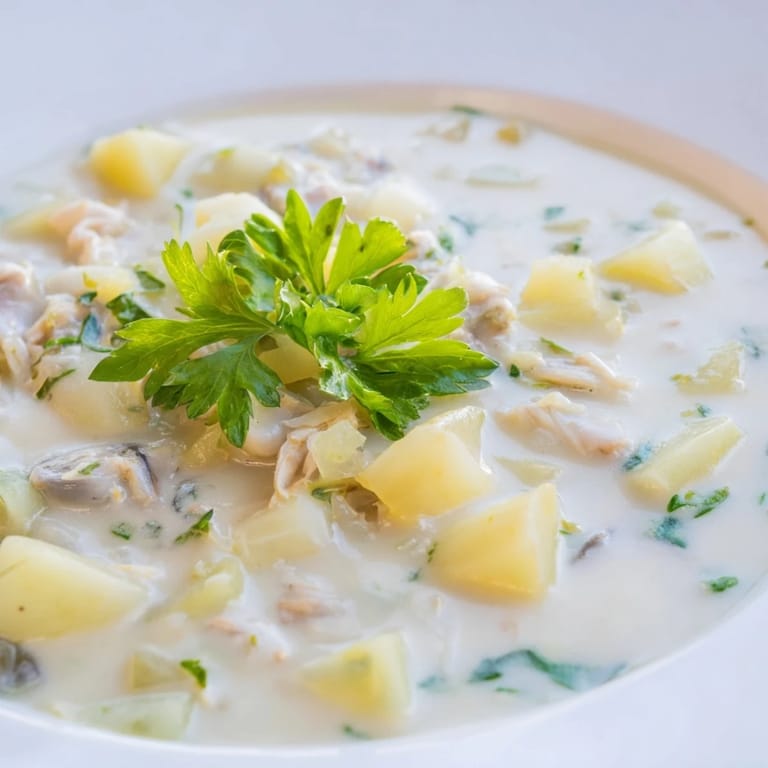 A hearty bowl of New England Clam Chowder, filled with tender clams and creamy potatoes; comfort food.