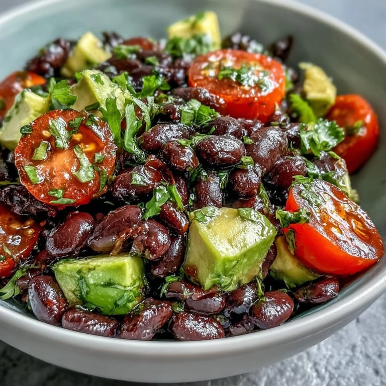 This nourishing Black Bean and Veggie Bowl features creamy avocado, sweet corn, and tangy lime dressing, topped with fresh cilantro and pumpkin seeds.  