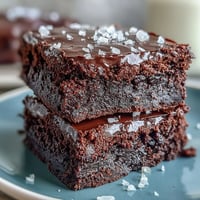 Rich, fudgy sourdough discard brownies topped with flaky sea salt for a sweet-salty dessert experience.  