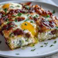 Amish Breakfast Casserole with Hash Browns, Eggs and Sausage: A golden-baked dish filled with crispy hash browns, savory sausage, and melted cheese, perfect for family breakfasts.