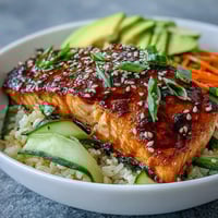Quick teriyaki salmon bowl with glazed salmon, fresh vegetables, and jasmine rice, perfect for a healthy summer dinner.  